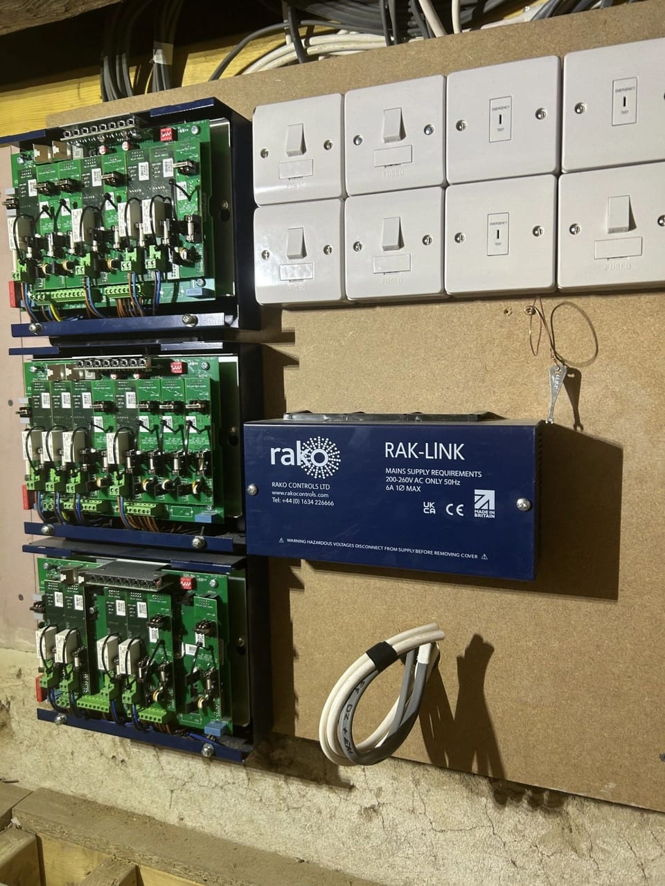 Lighting control modules installed beside a bank of switch plates