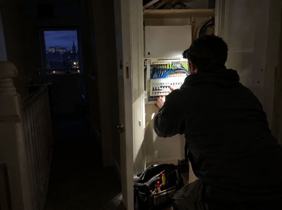 Working by head torch at a consumer unit during a power cut